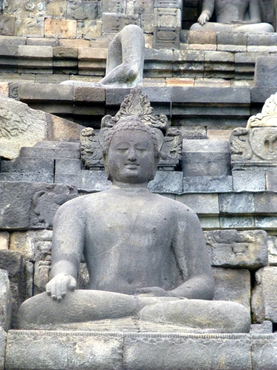 a statue of the god, buddha or other mythical object in the ruins