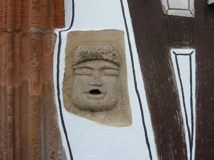 a buddha head is in between two building windows