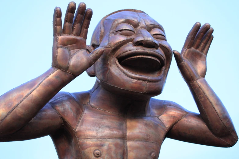 a statue is shown with its hands up