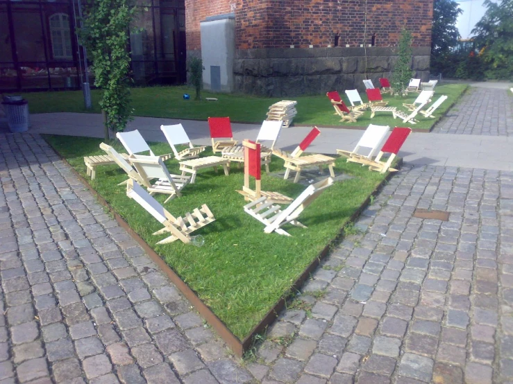 a line of lawn chairs are on the grass