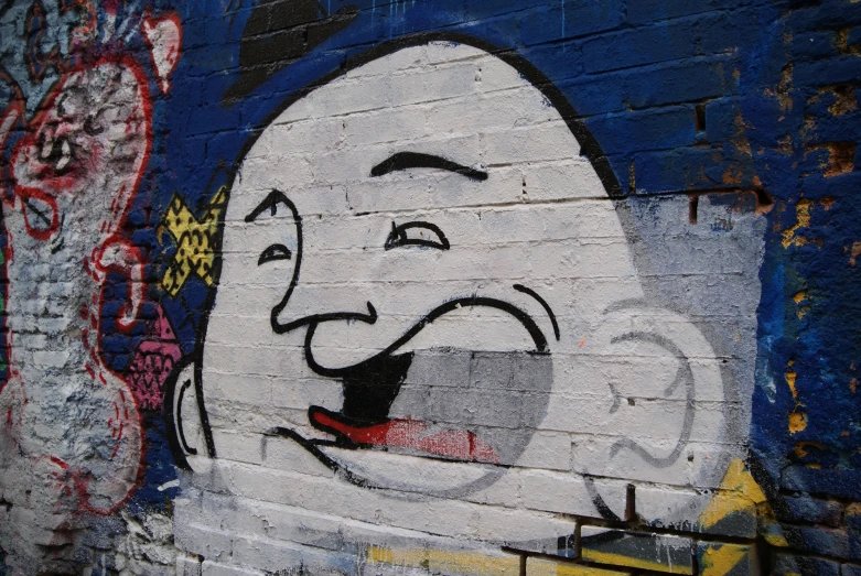a close up of a wall with a graffitti character