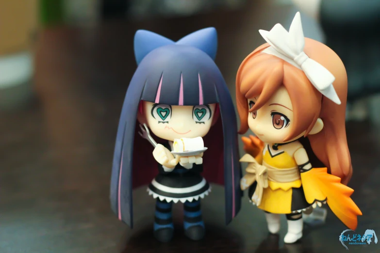 two figurines of characters one is anime girl