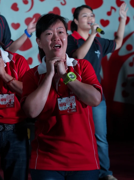 people singing in a heart - shaped wall