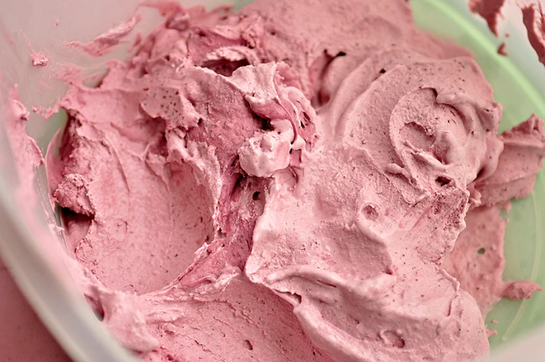 a bowl filled with cake frosting sitting on a table