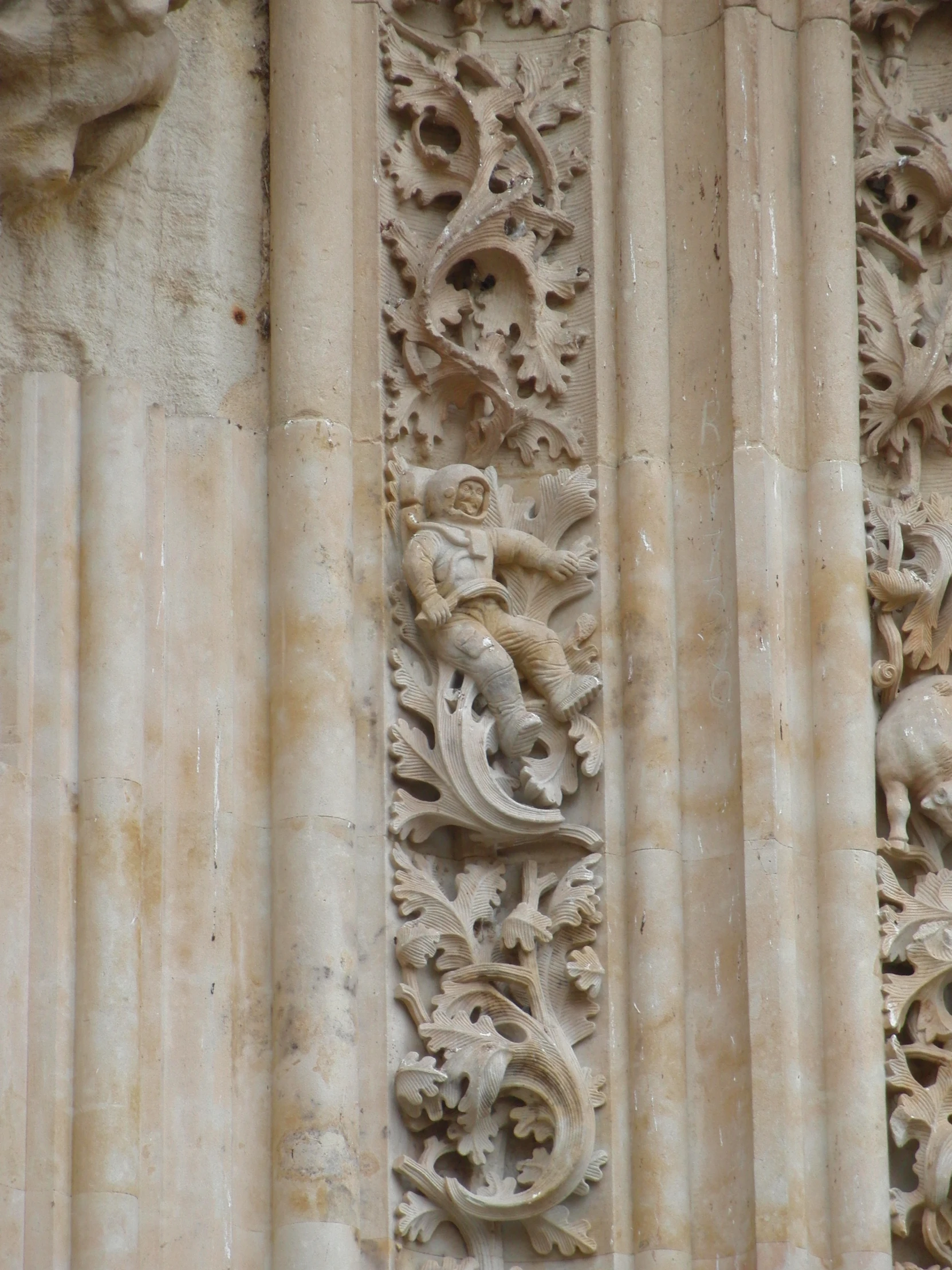 the carvings on a stone wall feature flowers and dragon heads