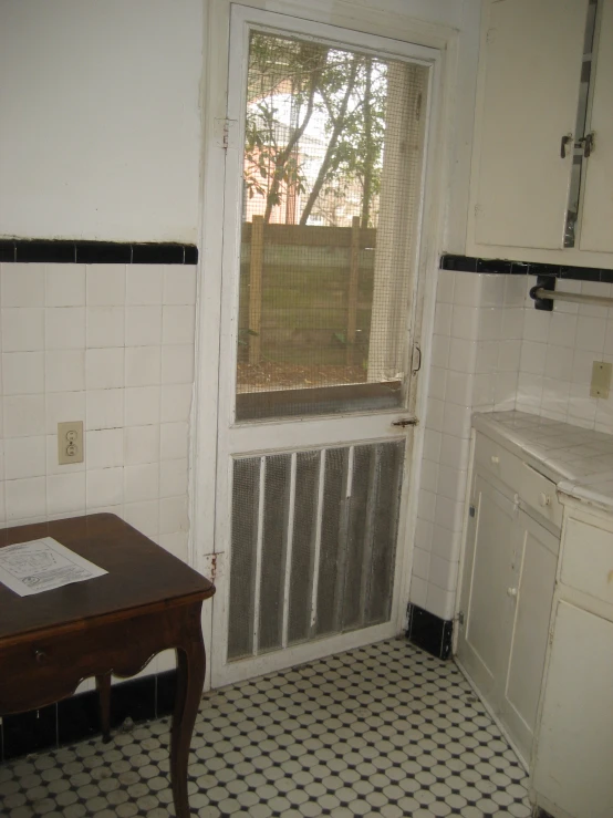 a kitchen with tiled floors and white appliances