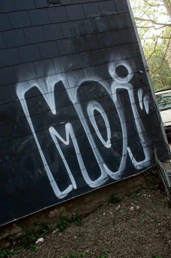 a large piece of graffiti has the word slow on it