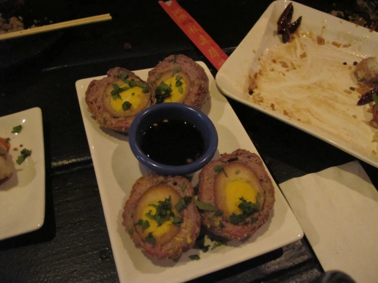 several small plates are sitting on the table with food in them