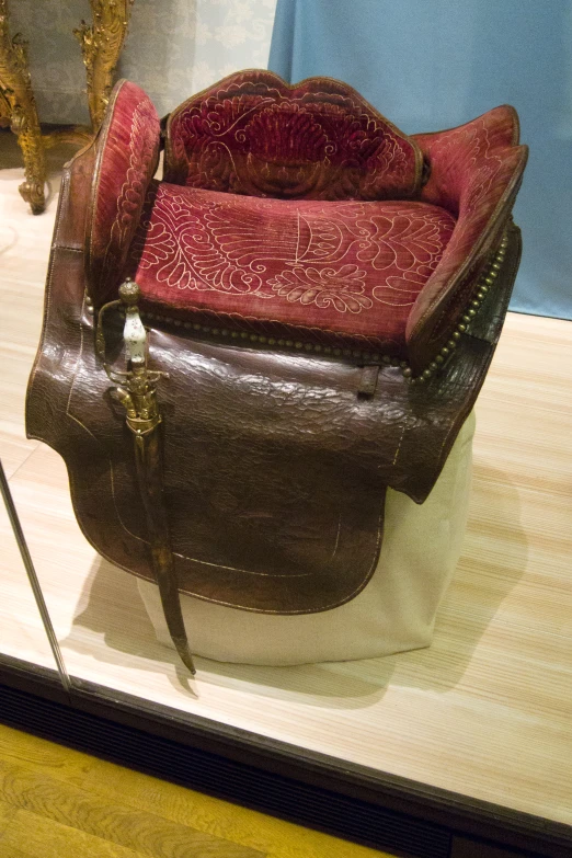 an old chair on display on a white surface