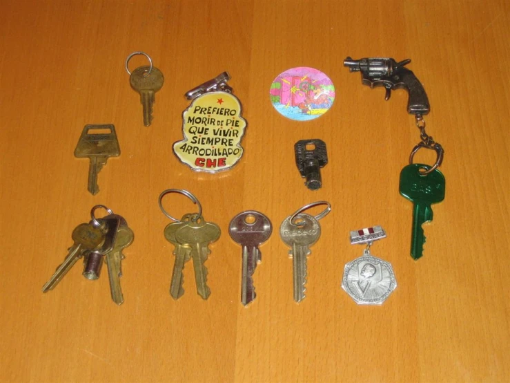 several different keys and keychains sitting on top of a table
