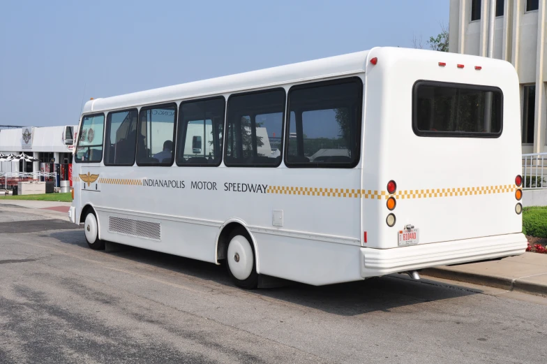 a white tour bus parked on a city street