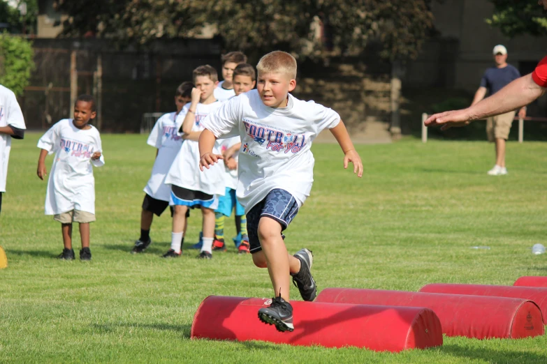 a bunch of s watching soing that looks like a  running with a ball