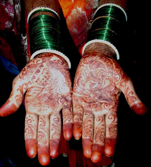 hands with henna on them with intricate design