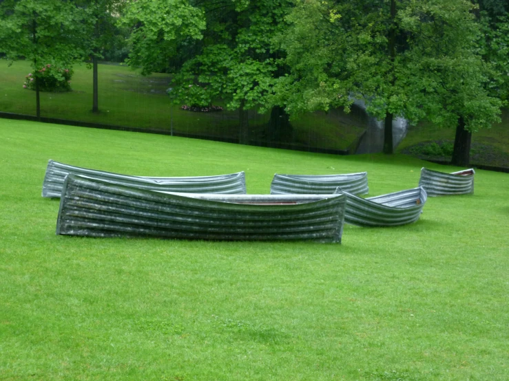 several benches are stacked on each other in the grass