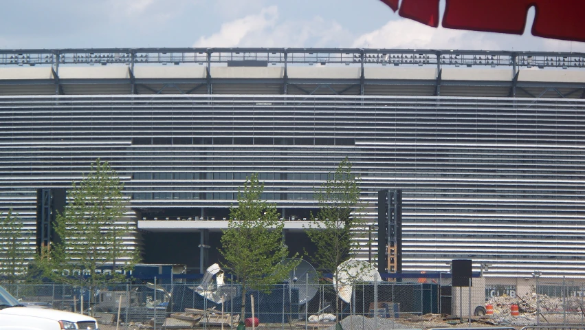 a large metal structure next to a parking lot