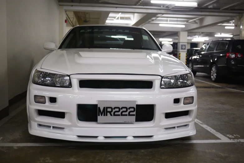 there is a white car parked in a parking garage