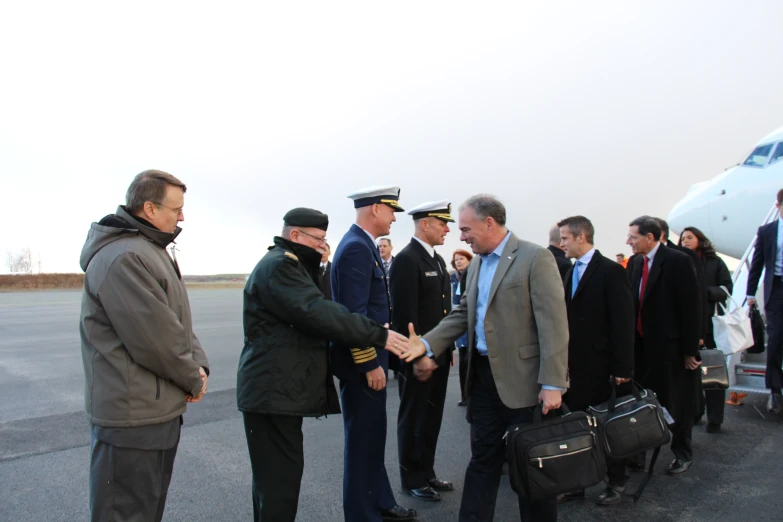 a group of people stand outside an air port