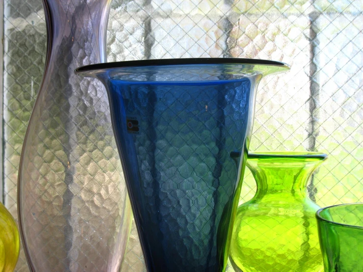 glass vases are placed in various colors