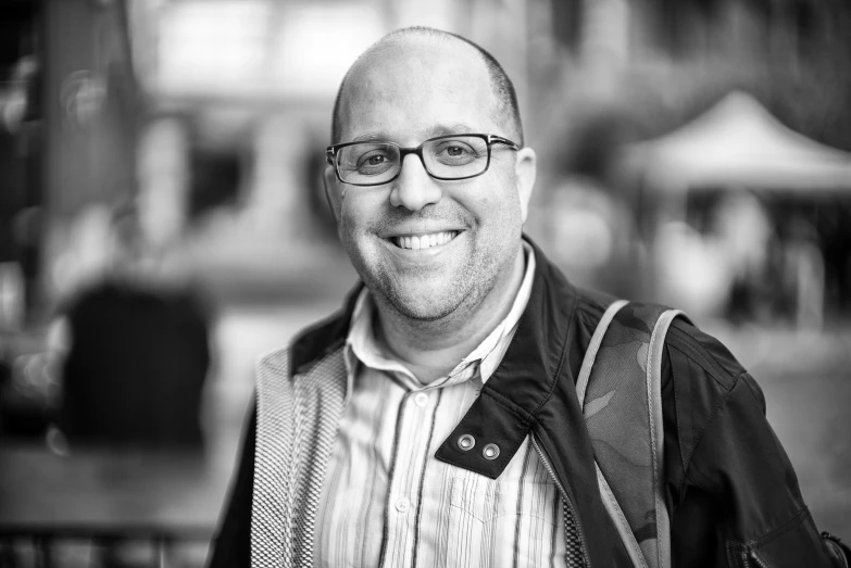 a black and white pograph of a man wearing glasses