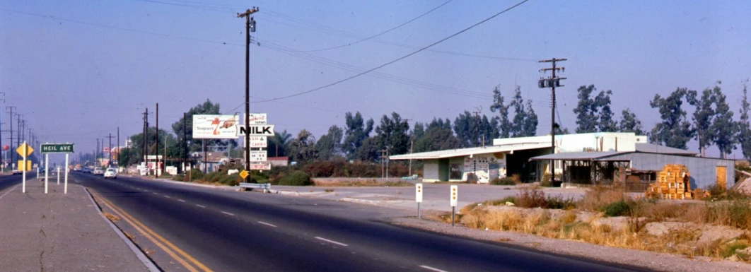 an empty road with gas pumps on one side and no cars