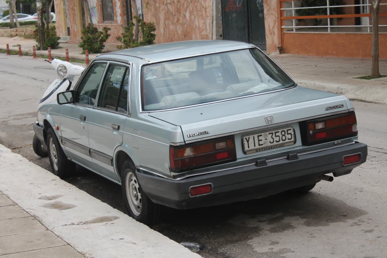 a small car parked next to a street curb