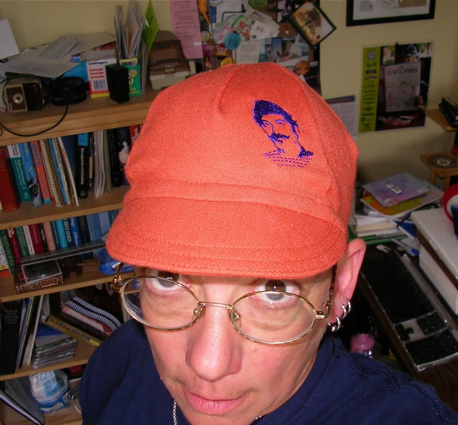 a person wearing a orange hat and glasses