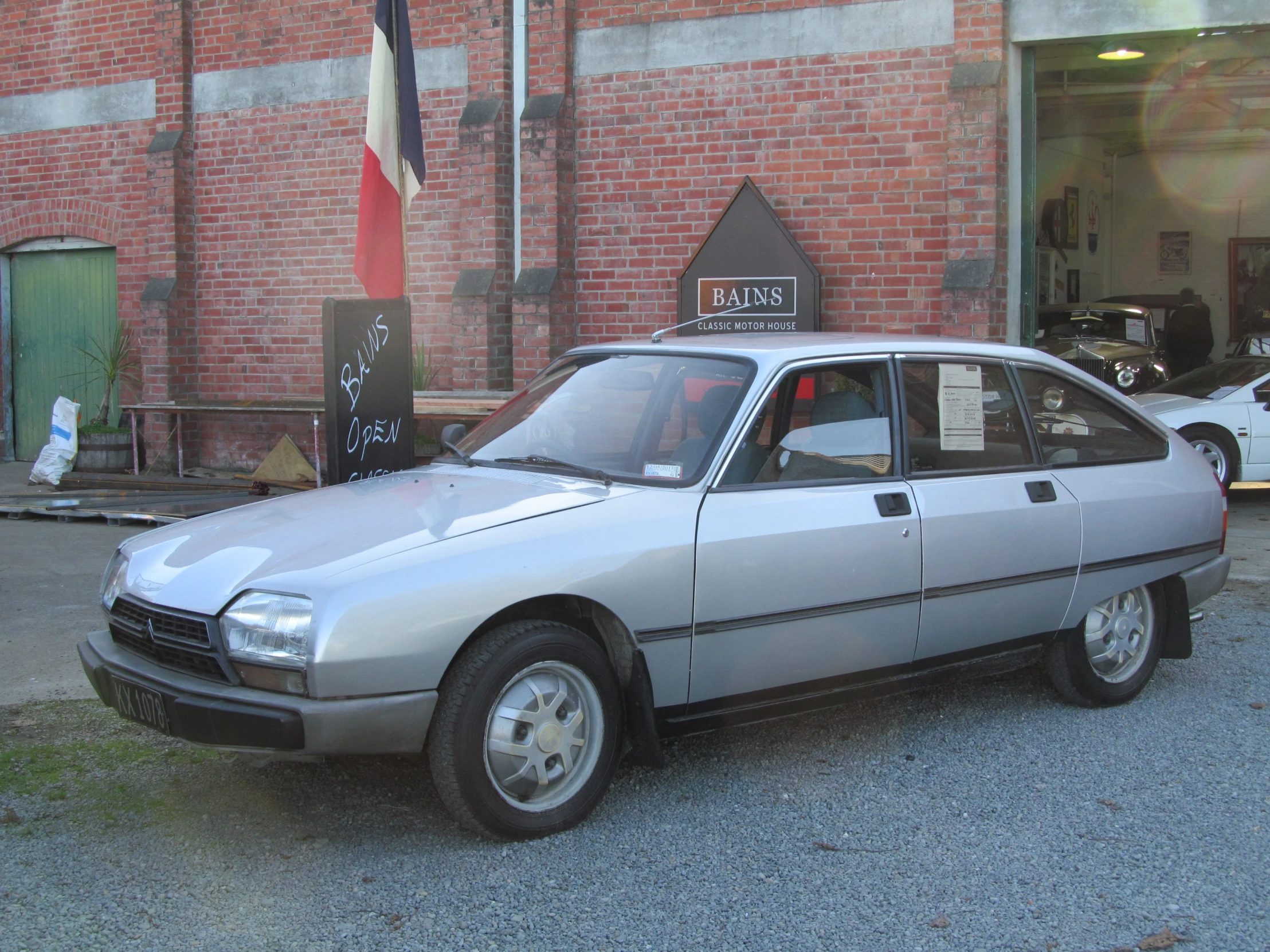 a silver car parked in front of a building