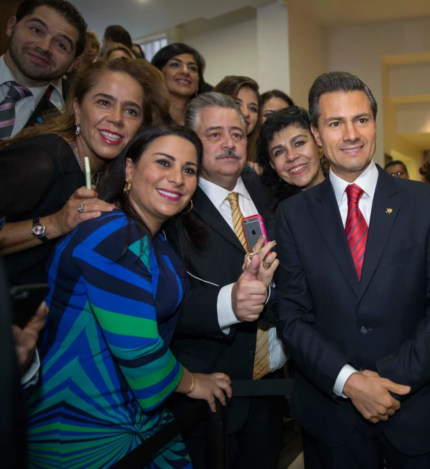 people in suits standing together for a pograph