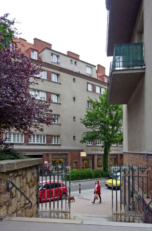 an alley way in a european city where cars are parked