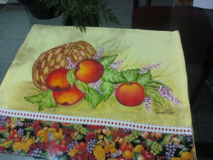 a table cloth on a tile floor with a painted tablecloth