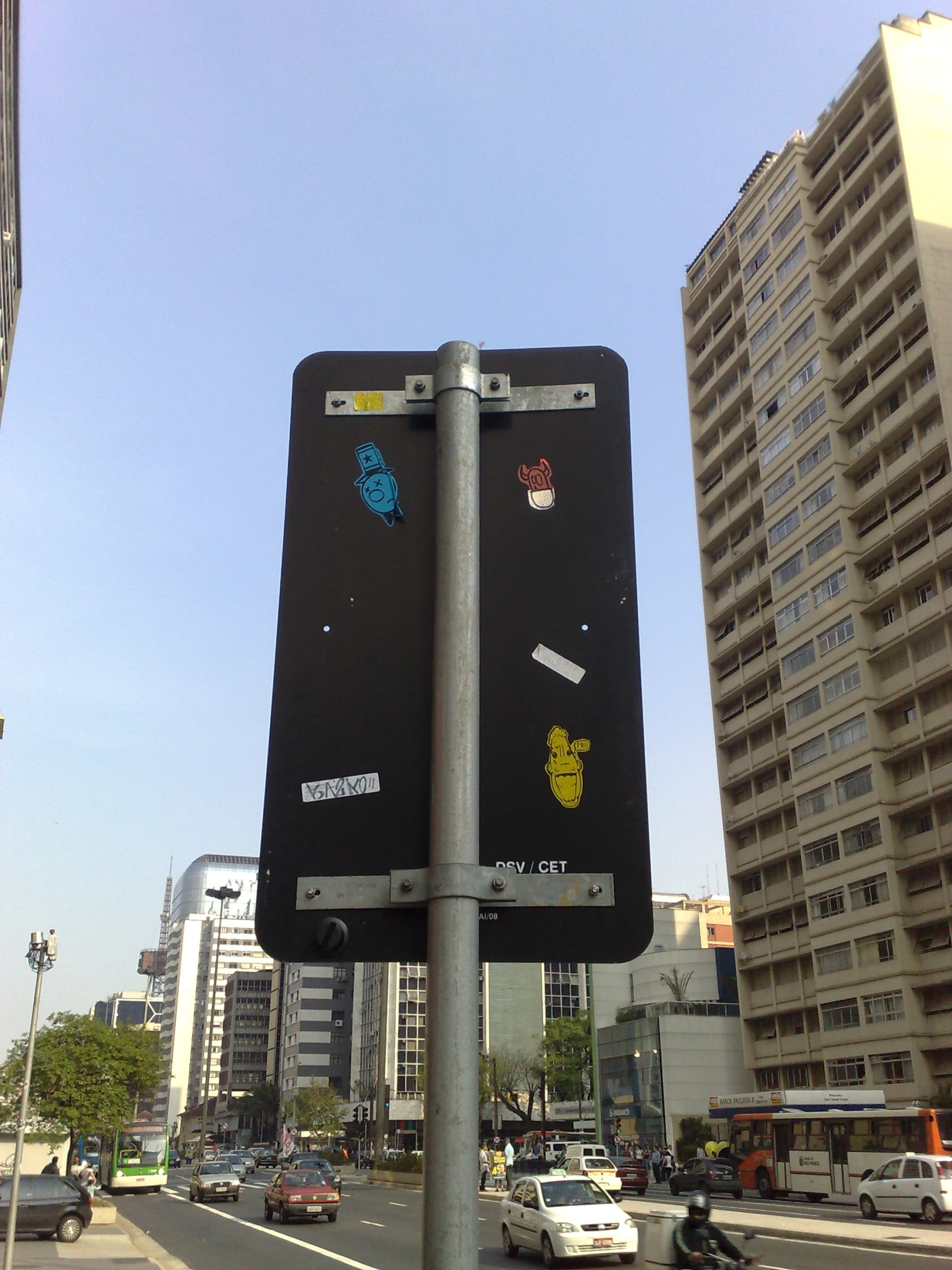 a street sign on a pole next to a road