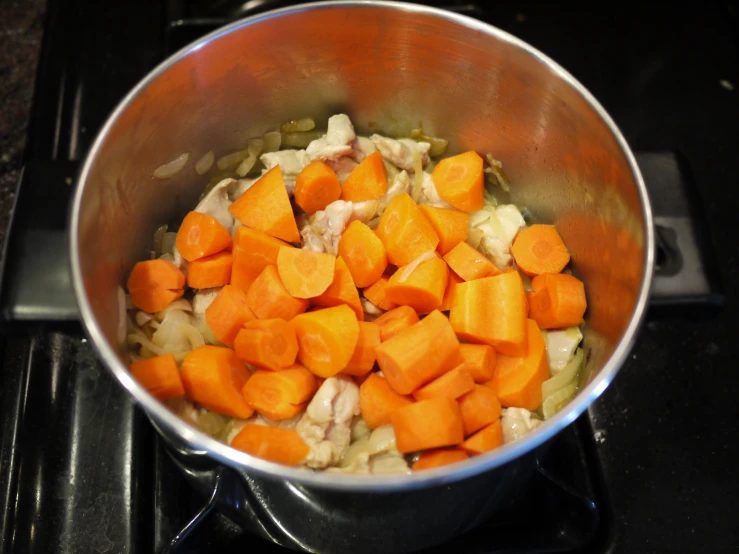 a pan filled with food next to an electric stove