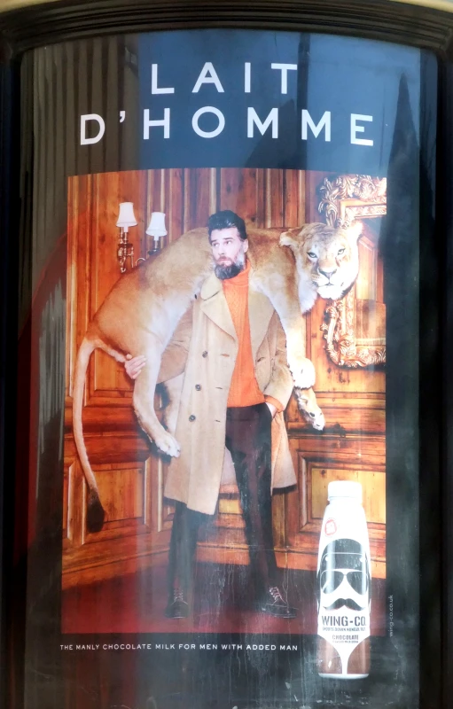 a poster of a lion being held by a man in a suit