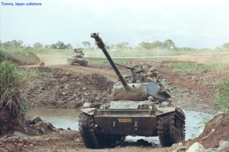 several men sitting on top of military vehicles