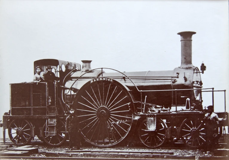 an old time picture of a black and white locomotive