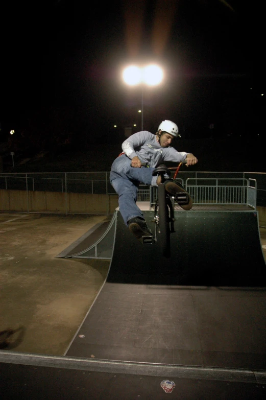 a skateboarder rides a bike over an obstacle