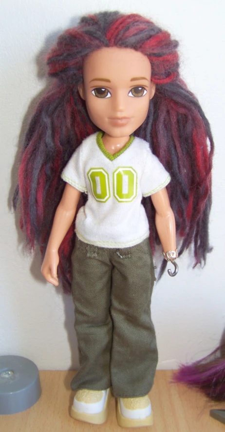 a doll wearing a white shirt and brown pants