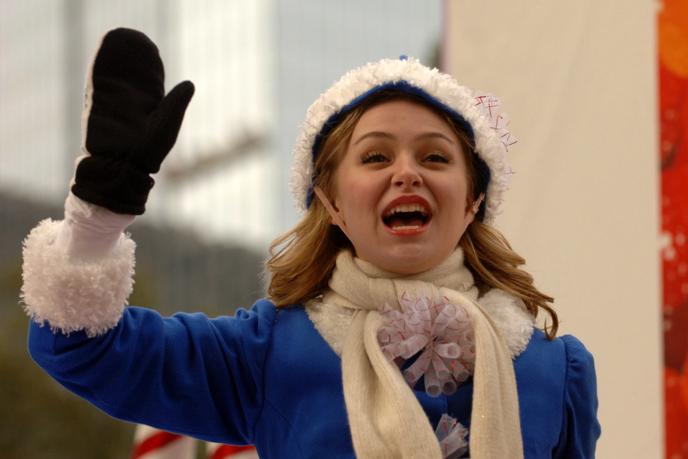 the woman is dressed in a blue and white outfit