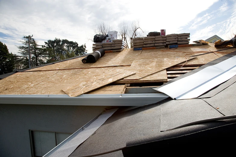 a roof is covered with wood being poured on the top of it