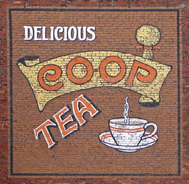 a painted sign for the famous tea shop on a brick wall