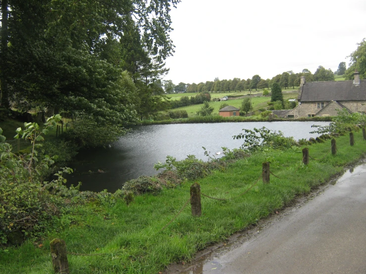 a house next to a lake in the country side