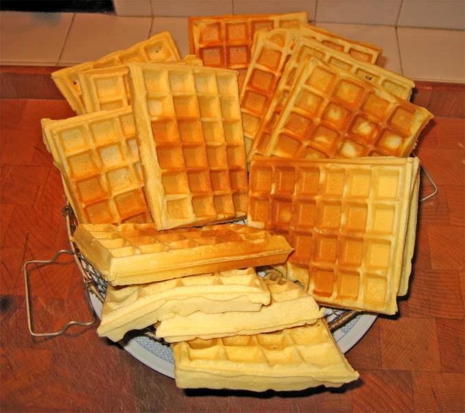 a plate topped with waffles sitting on top of a counter