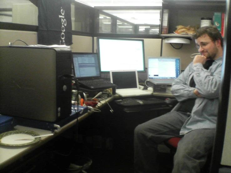 a man sits at a desk in an office