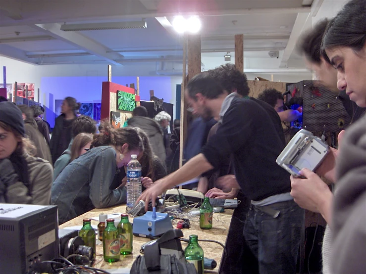 a group of people at a convention that has a project being made