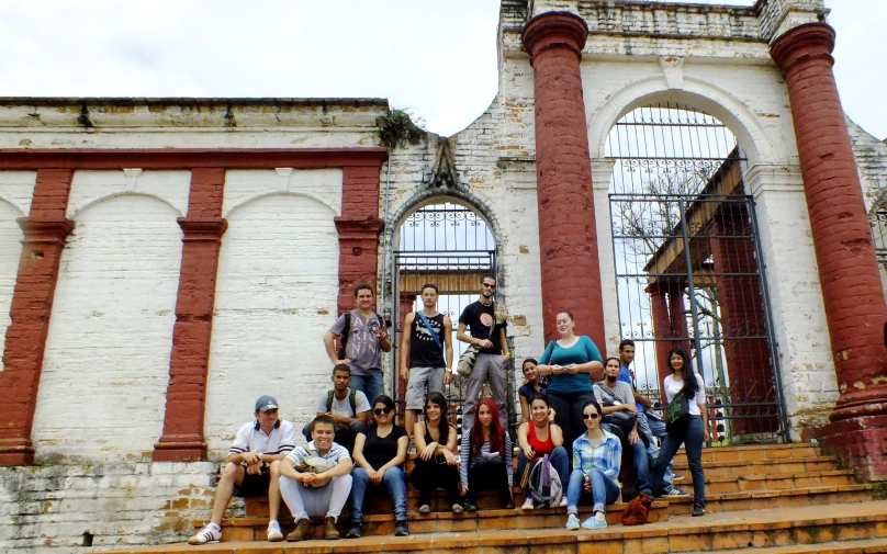 the group is posing on the stairs outside the building