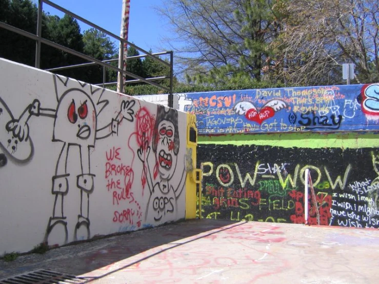 graffiti is on a wall next to a skateboard park