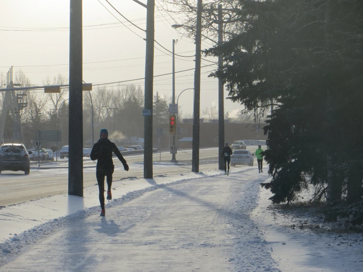 a man running down the road during a cold, sunny day