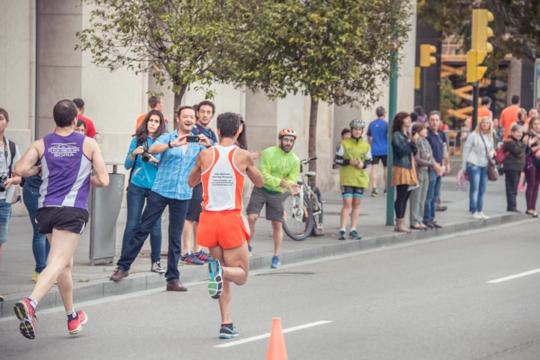 several runners running down the street in a race