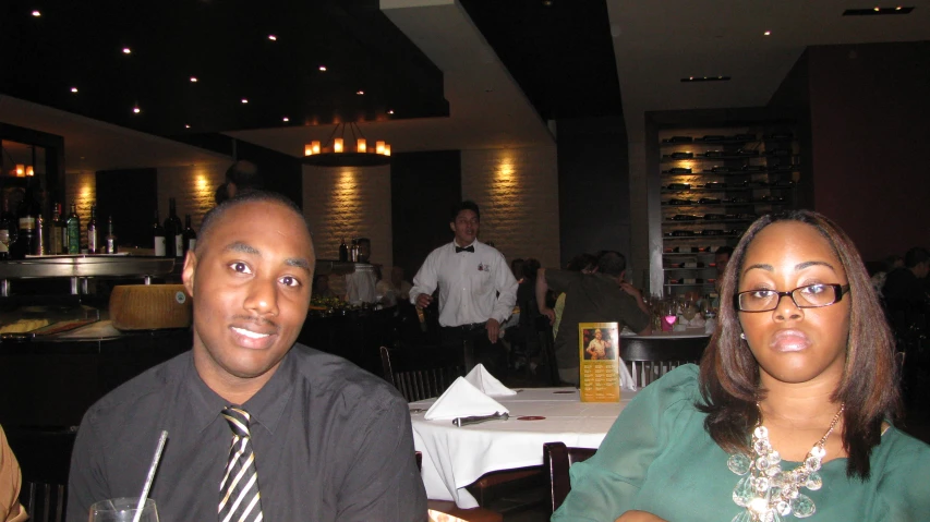 a man and a woman sitting next to each other at a table