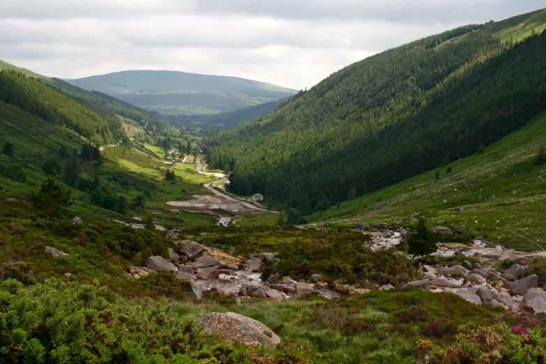 a mountain view, looking down at the green hills